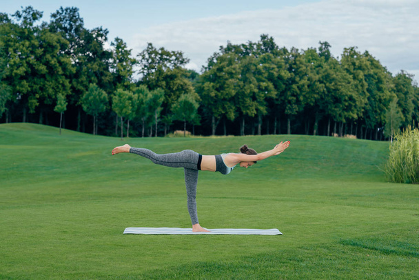 woman standing in yoga pose - Фото, изображение