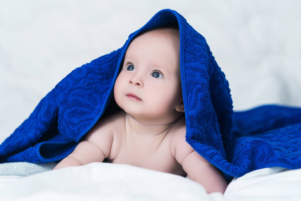 Cute baby after shower with blue towel on head - 写真・画像