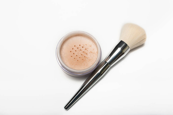 Mineral loose powder and cosmetic brush on a white background - Photo, Image