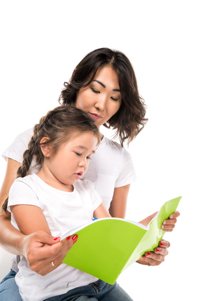  mother and daughter writing in copybook - Photo, Image