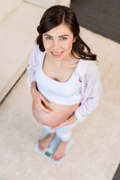 pregnant woman standing on scales - Photo, Image