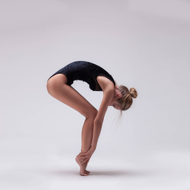 young beautiful dancer in black swimsuit - Valokuva, kuva