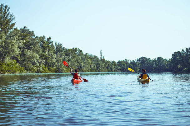 A canoe trip along the river along the forest in summer. - Φωτογραφία, εικόνα