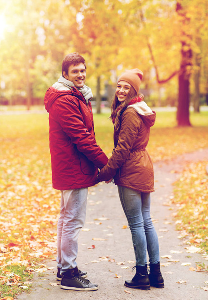 happy young couple walking in autumn park - Photo, Image