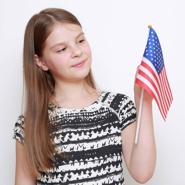 little girl holding USA flag in studio - Zdjęcie, obraz