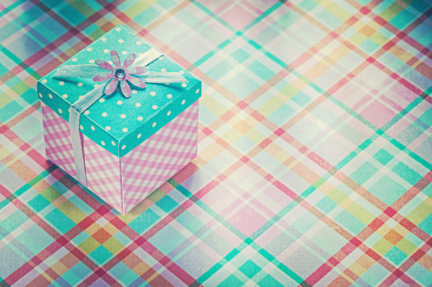 Wrapped present box on checked fabric background holidays concep - Foto, Imagem