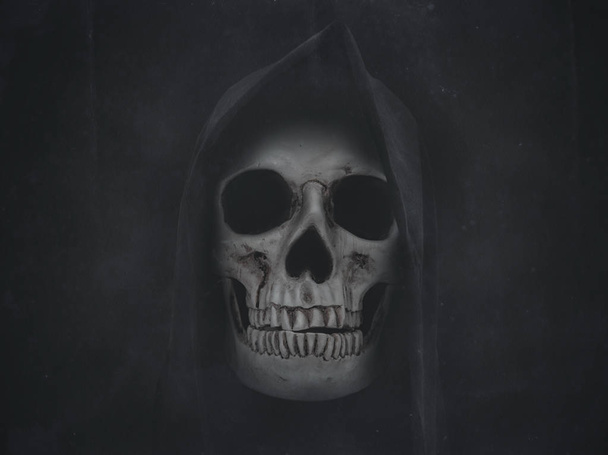 Human skull in hood. Halloween grunge background - Fotó, kép