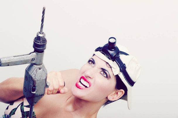 Girl with a hand drill - Foto, imagen
