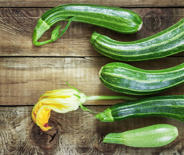 Fresh zucchini on dark wooden background - Foto, imagen