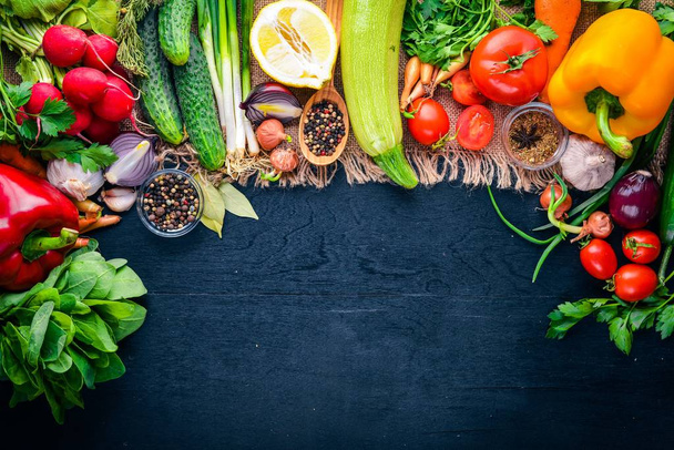 Frame of organic food. Fresh raw vegetables and spices. On a wooden chalkboard. - Фото, зображення