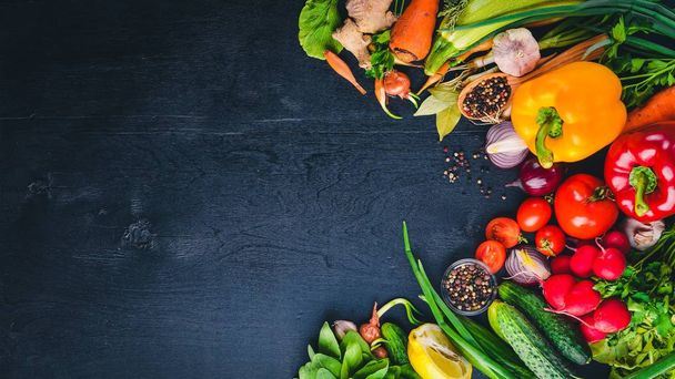 Frame of organic food. Fresh raw vegetables and spices. On a wooden chalkboard. - 写真・画像