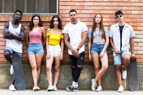 Group of young hipster friends looking at camera in an urban area. - Fotoğraf, Görsel