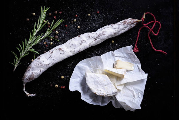 Salami, cheese and herbs. Traditional spanish fuet snack.  - Valokuva, kuva