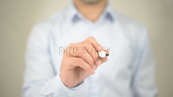Paid Survey , man writing on transparent screen - Photo, Image