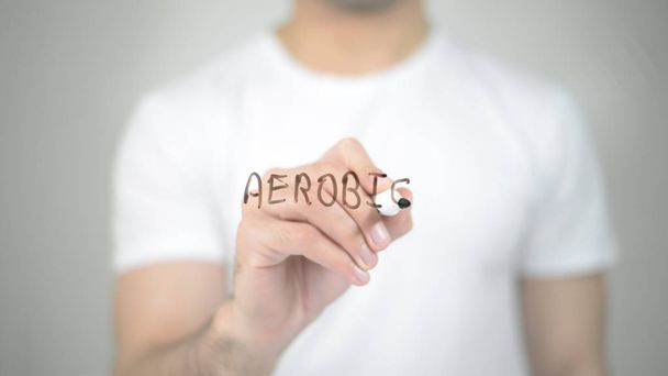 Aerobic, man writing on transparent screen - Photo, Image
