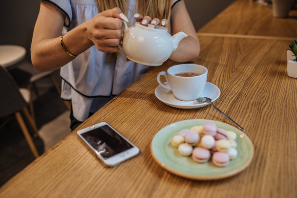 Woman with phone and hot  tea  - Photo, Image