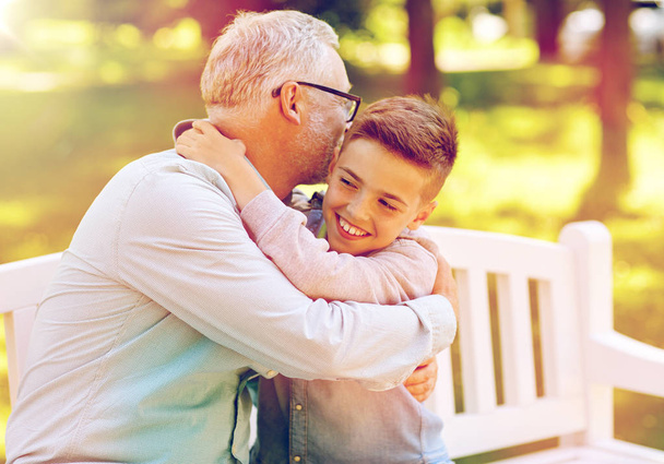 grandfather and grandson hugging at summer park - Foto, imagen
