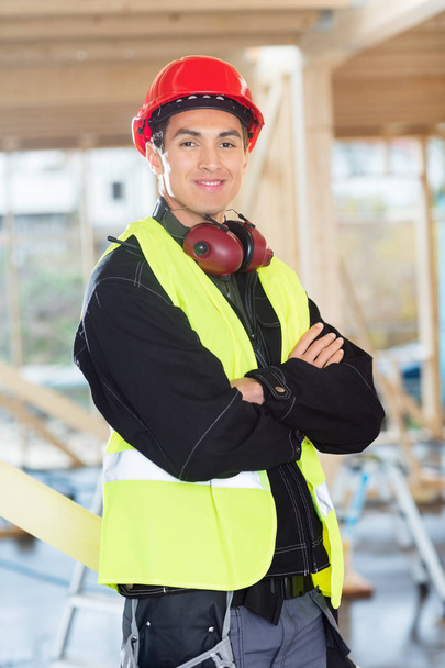Carpenter Standing Arms Crossed At Construction Site - Photo, image