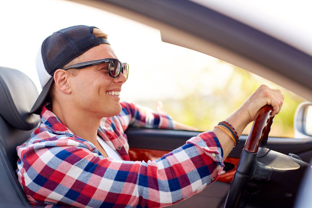 happy young man in shades driving convertible car - Photo, Image