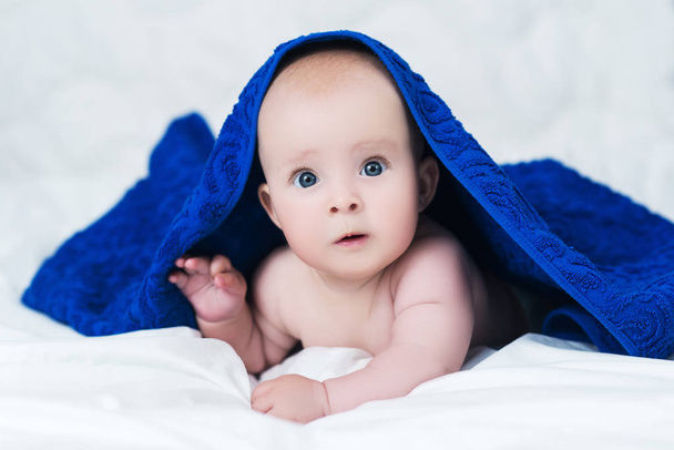 Cute baby after shower with blue towel on head - Photo, image
