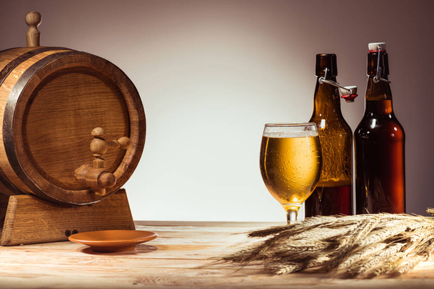 beer barrel, glass and bottles  - Photo, Image
