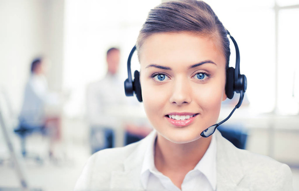 helpline operator with headphones in call centre - Foto, afbeelding