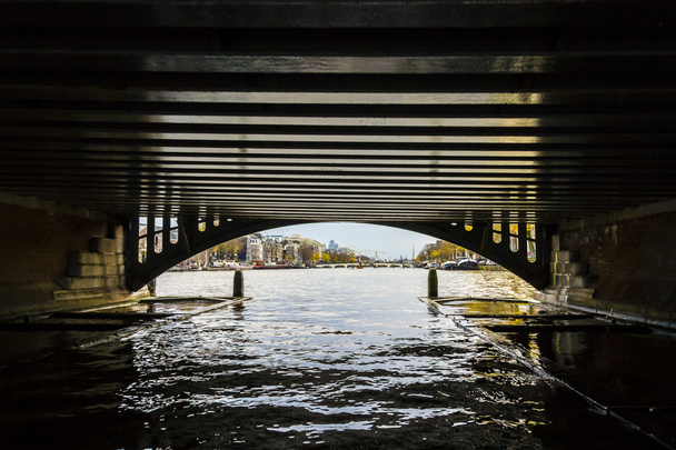 Kijk onder de brug naar amsterdam in de late herfst, amstel - Foto, afbeelding