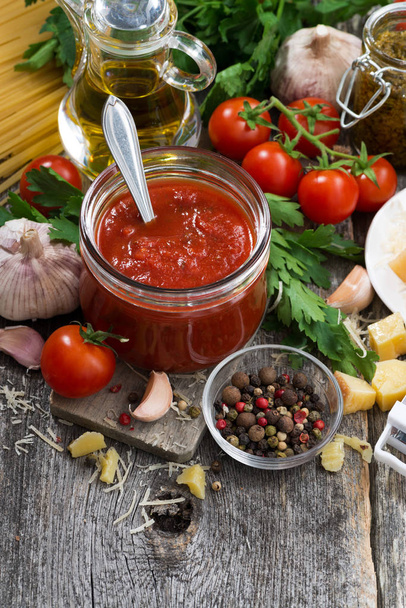 tomato sauce in a glass jar and ingredients  - Fotografie, Obrázek