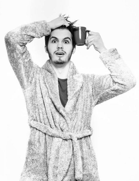 handsome bearded man with cup in terry bathrobe - Fotó, kép