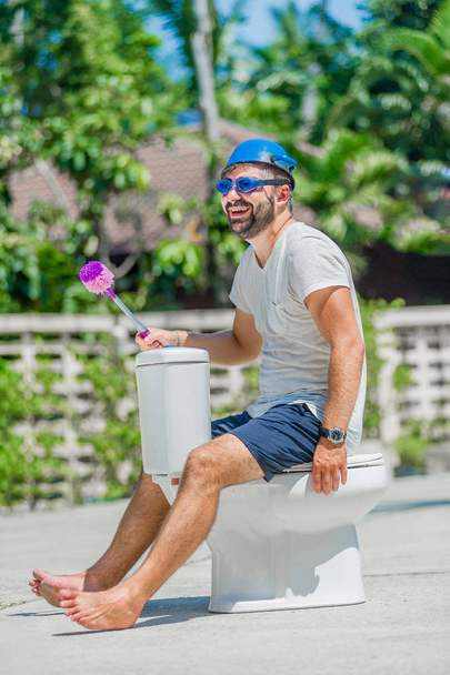 The bearded man in goggles astride the toilet, which is installe - Photo, Image