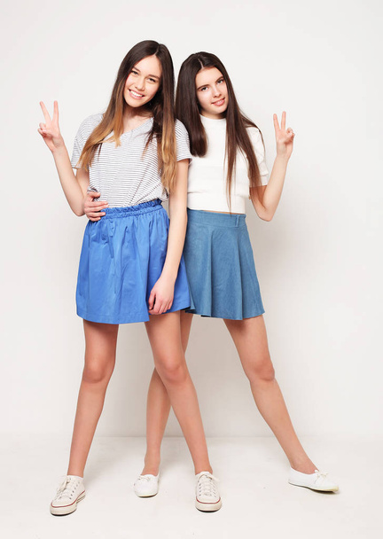 Full body portrait of two happy  girls over white background - Photo, Image