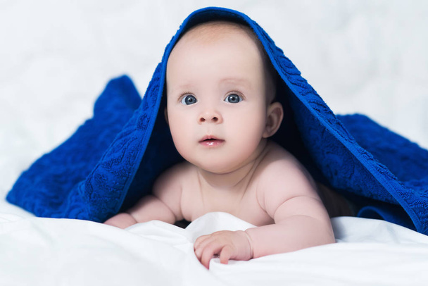 Cute baby after shower with blue towel on head - Foto, Imagen