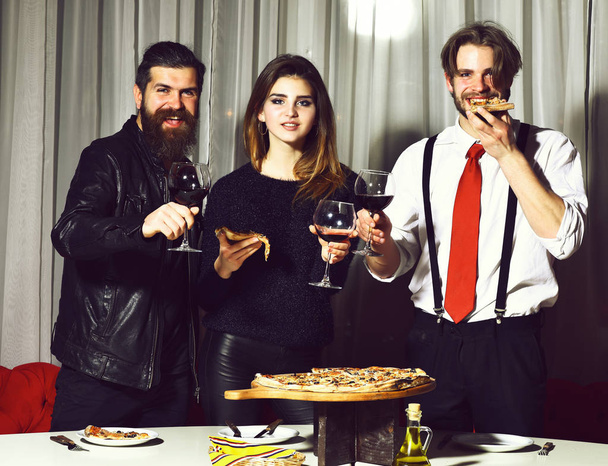 Happy friends toasting glasses and eating pizza - Φωτογραφία, εικόνα