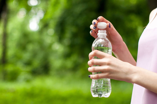 Close-up plastic water bottle in woman hand - Photo, Image