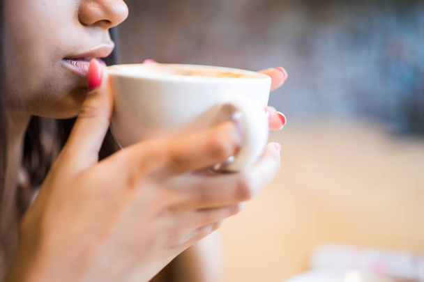closeup portrait of young woman with coffee drink - Foto, afbeelding