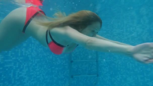 Woman underwater, a woman with big breasts floating under the water. Underwater photography. 4k, slow motion - Footage, Video