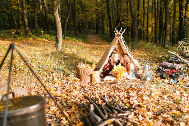 Man en vrouw wandelaars in de herfst natuur kamperen. Gelukkige jonge paar backpackers kamperen in de tent. - Foto, afbeelding