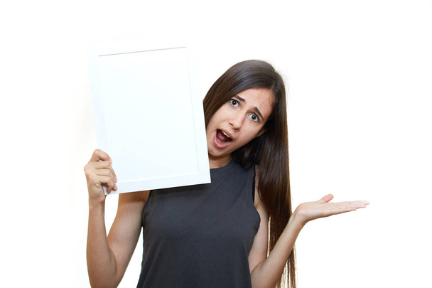 The girl is holding a poster. White background. Emotions - Φωτογραφία, εικόνα
