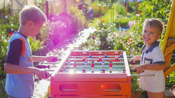 children playing table football outdoors.Fun outdoors - Photo, Image