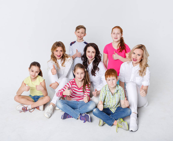 Happy kids and adults standing at white background, copy space - Photo, Image