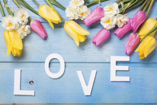 Woord van liefde en roze, geel en wit bloemen  - Foto, afbeelding