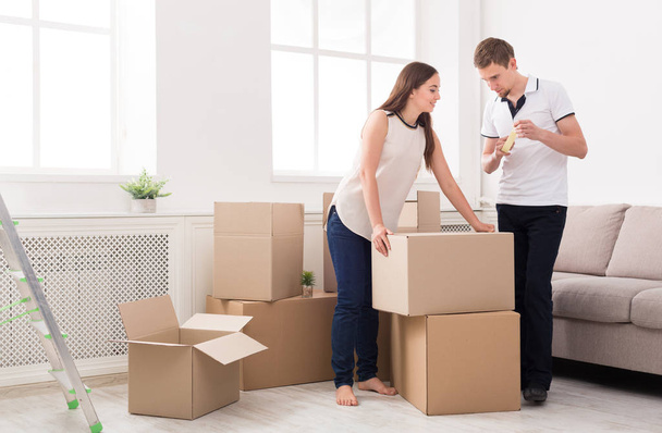 Young couple unpacking moving boxes - Photo, Image