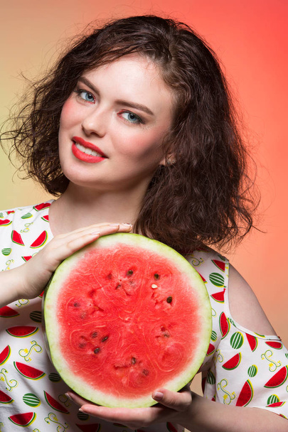 Girl with makeup holds a cut watermelon - Photo, Image