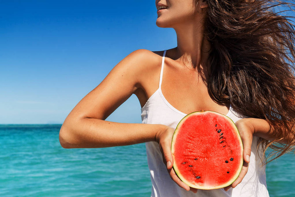 young woman having fun with watermelon on the beach - Foto, afbeelding