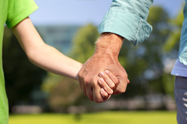 senior man and child holding hands - Фото, изображение