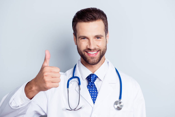 Successful young handsome and stylish bearded doctor in white un - Foto, imagen