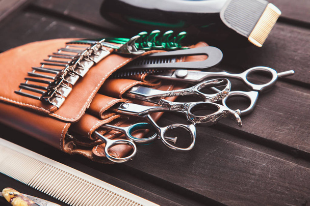 Beautiful professional tools professional Barber kits, scissors, a sharp razor, mechanical and electronic hair clippers, hair curlers, clips. Vintage stylish background for beauty salon with free space - Valokuva, kuva
