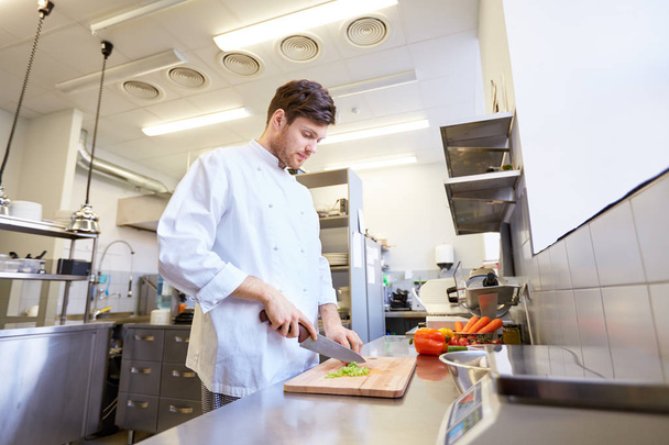 happy male chef cooking food at restaurant kitchen - 写真・画像