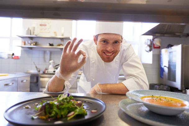 happy male chef cooking food at restaurant kitchen - Valokuva, kuva