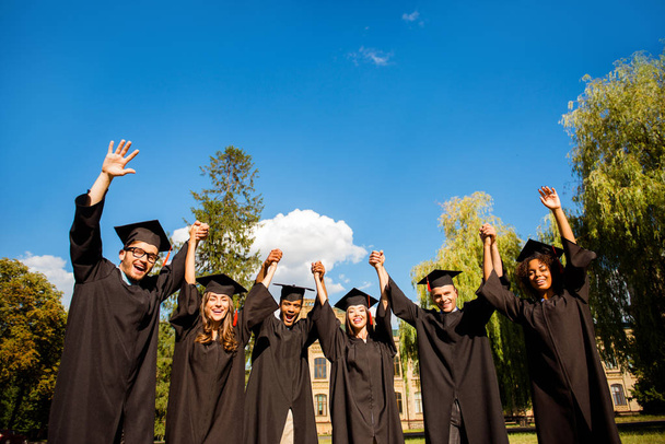 Six excited successful graduates in black robes and mortar-board - Fotó, kép